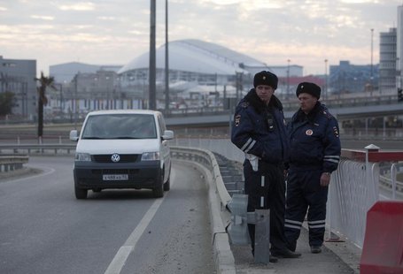 Russian traffic police officers stand guard during patrol on a road near venues at the Olympic Park near Sochi January 7, 2014. REUTERS/Kazb Russian traffic police officers stand guard during patrol on a road near venues at the Olympic Park near Sochi January 7, 2014. REUTERS/Kazb