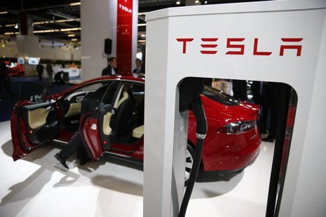 A Tesla model S car with an electric vehicle charging station is displayed during a media preview day at the Frankfurt Motor Show (IAA) Sept A Tesla model S car with an electric vehicle charging station is displayed during a media preview day at the Frankfurt Motor Show (IAA) Sept