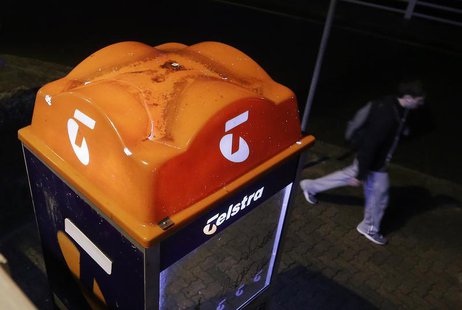 A man walks past a Telstra public phone in Sydney August 8, 2013. REUTERS/Daniel Munoz A man walks past a Telstra public phone in Sydney August 8, 2013. REUTERS/Daniel Munoz