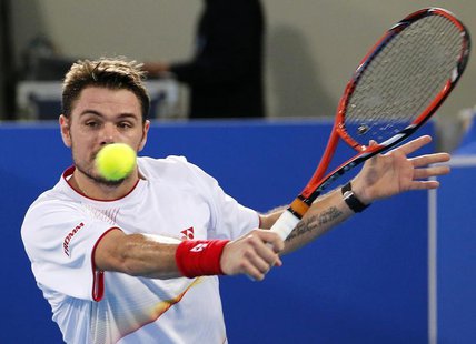 Stanislas Wawrinka of Switzerland hits a return to David Ferrer of Spain during Mubadala World Tennis Championship in Abu Dhabi December 26, Stanislas Wawrinka of Switzerland hits a return to David Ferrer of Spain during Mubadala World Tennis Championship in Abu Dhabi December 26,
