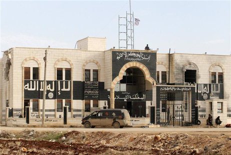 Rebel fighters stand guard at a former base used by fighters from the Islamic State in Iraq and the Levant (ISIL), after they captured it fr Rebel fighters stand guard at a former base used by fighters from the Islamic State in Iraq and the Levant (ISIL), after they captured it fr