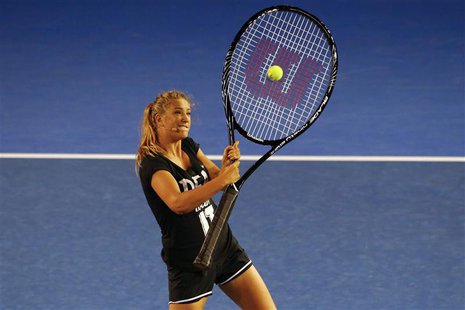 Victoria Azarenka of Belarus hits a ball with an oversized tennis racquet during the Kids Tennis Day before the Australian Open 2014 tennis Victoria Azarenka of Belarus hits a ball with an oversized tennis racquet during the Kids Tennis Day before the Australian Open 2014 tennis