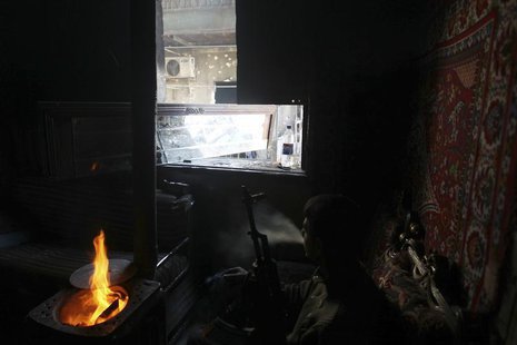 A Free Syrian Amy fighter rests in a damaged house in the Aghyol area of Aleppo January 11, 2014. REUTERS/Jalal Alhalabi A Free Syrian Amy fighter rests in a damaged house in the Aghyol area of Aleppo January 11, 2014. REUTERS/Jalal Alhalabi