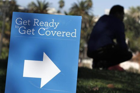 A man is silhouetted behind a sign at an Affordable Care Act outreach event hosted by Planned Parenthood for the Latino community in Los Ang A man is silhouetted behind a sign at an Affordable Care Act outreach event hosted by Planned Parenthood for the Latino community in Los Ang
