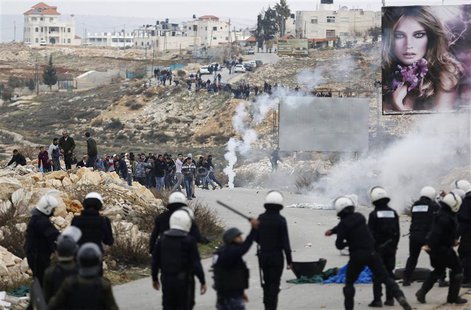 Palestinian policemen (backs to camera) stand in front of demonstrators outside the Jalazoun refugee camp near the West Bank city of Ramalla Palestinian policemen (backs to camera) stand in front of demonstrators outside the Jalazoun refugee camp near the West Bank city of Ramalla