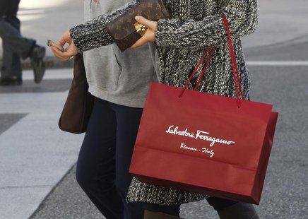 A shopper carries her purchases from the Salvatore Ferragamo boutique on Rodeo Drive, ahead of the Christmas festive season in Beverly Hills A shopper carries her purchases from the Salvatore Ferragamo boutique on Rodeo Drive, ahead of the Christmas festive season in Beverly Hills