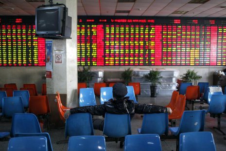 An investor sits in front of an electronic board showing stock information at a brokerage house in Shanghai, January 2, 2014. REUTERS/Aly So An investor sits in front of an electronic board showing stock information at a brokerage house in Shanghai, January 2, 2014. REUTERS/Aly So