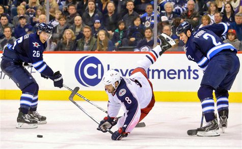 Jan 11, 2014; Winnipeg, Manitoba, CAN; Columbus Blue Jackets forward Nathan Horton (8) falls as he battles for the puck with Winnipeg Jets d Jan 11, 2014; Winnipeg, Manitoba, CAN; Columbus Blue Jackets forward Nathan Horton (8) falls as he battles for the puck with Winnipeg Jets d
