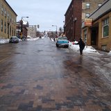 Duluth women putting salt on an icy street. Duluth women putting salt on an icy street.