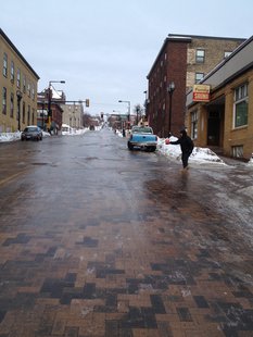 Duluth women putting salt on an icy street. Duluth women putting salt on an icy street.