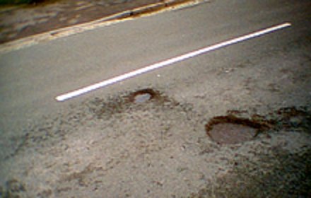 Potholes are caused by freezing and thawing in the pavement which causes cracks and is then pounded by cars and trucks opening up chasms. Potholes are caused by freezing and thawing in the pavement which causes cracks and is then pounded by cars and trucks opening up chasms.