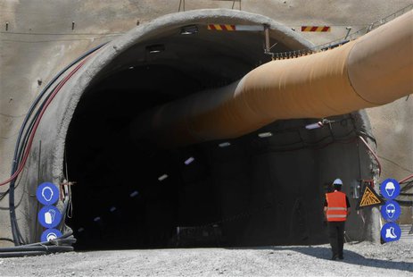 A worker walks towards a tunnel at the Hellas Gold facilities in Skouries at Halkidiki region in northern Greece in this picture taken Augus A worker walks towards a tunnel at the Hellas Gold facilities in Skouries at Halkidiki region in northern Greece in this picture taken Augus