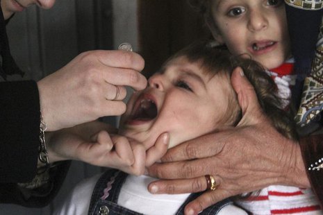 An activist health worker administers a polio vaccination to a child in Aleppo January 5, 2014. REUTERS/Hosam Katan An activist health worker administers a polio vaccination to a child in Aleppo January 5, 2014. REUTERS/Hosam Katan