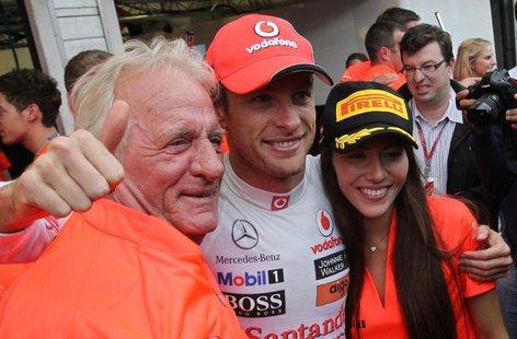 McLaren Formula One driver Jenson Button of Britain poses for pictures with his father John and girlfriend Jessica Michibata after the Hunga McLaren Formula One driver Jenson Button of Britain poses for pictures with his father John and girlfriend Jessica Michibata after the Hunga