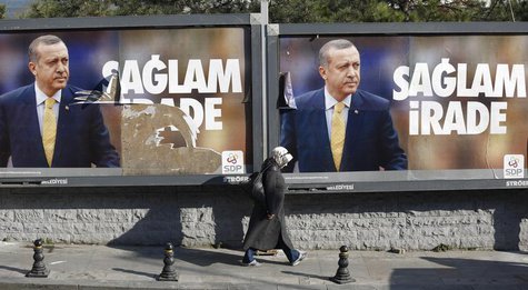 A woman walks past by billboards with pictures of Turkish Prime Minister Tayyip Erdogan, in Istanbul January 13, 2014. REUTERS/Murad Sezer A woman walks past by billboards with pictures of Turkish Prime Minister Tayyip Erdogan, in Istanbul January 13, 2014. REUTERS/Murad Sezer