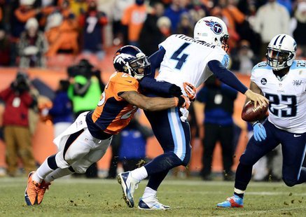 Dec 8, 2013; Denver, CO, USA; Denver Broncos cornerback Chris Harris (25) tackles Tennessee Titans quarterback Ryan Fitzpatrick (4) in the f Dec 8, 2013; Denver, CO, USA; Denver Broncos cornerback Chris Harris (25) tackles Tennessee Titans quarterback Ryan Fitzpatrick (4) in the f