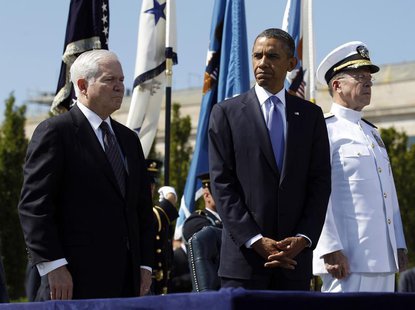 U.S. President Barack Obama (C) particpates in a farewell ceremony for retiring U.S. Defense Secretary Robert Gates (L) alongside Chairman o U.S. President Barack Obama (C) particpates in a farewell ceremony for retiring U.S. Defense Secretary Robert Gates (L) alongside Chairman o