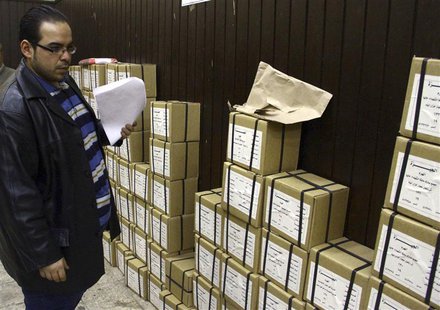 An election official stands next to boxes containing voting slips for a referendum on the new constitution in Cairo January 12, 2014. REUTER An election official stands next to boxes containing voting slips for a referendum on the new constitution in Cairo January 12, 2014. REUTER