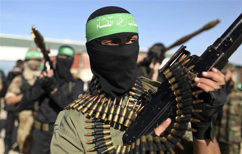Palestinian members of the al-Qassam brigades, the armed wing of the Hamas movement, stand guard as they wait for the arrival of Hamas chief Palestinian members of the al-Qassam brigades, the armed wing of the Hamas movement, stand guard as they wait for the arrival of Hamas chief