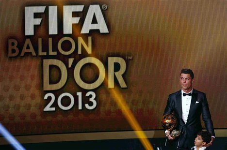 Portugal's Cristiano Ronaldo holds his trophy with his son Cristiano Ronaldo Jr after being awarded the FIFA Ballon d'Or 2013 in Zurich Janu Portugal's Cristiano Ronaldo holds his trophy with his son Cristiano Ronaldo Jr after being awarded the FIFA Ballon d'Or 2013 in Zurich Janu