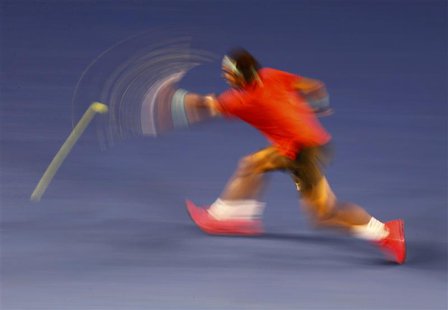 Rafael Nadal of Spain hits a return to Bernard Tomic of Australia during their men's singles match at the Australian Open 2014 tennis tourna Rafael Nadal of Spain hits a return to Bernard Tomic of Australia during their men's singles match at the Australian Open 2014 tennis tourna