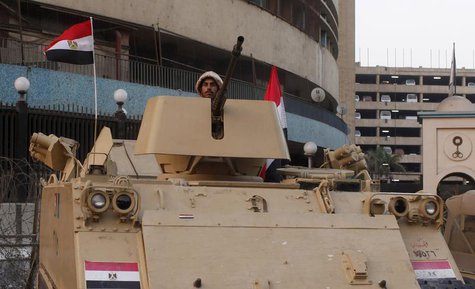 An Egyptian army soldier stands guard in front of the state television building in Cairo, July 9, 2013. REUTERS/Asmaa Waguih An Egyptian army soldier stands guard in front of the state television building in Cairo, July 9, 2013. REUTERS/Asmaa Waguih