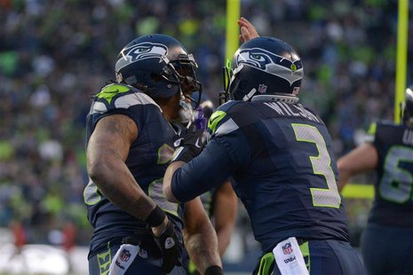 Jan 11, 2014; Seattle, WA, USA; Seattle Seahawks running back Marshawn Lynch (left) celebrates with quarterback Russell Wilson (3) after sco Jan 11, 2014; Seattle, WA, USA; Seattle Seahawks running back Marshawn Lynch (left) celebrates with quarterback Russell Wilson (3) after sco
