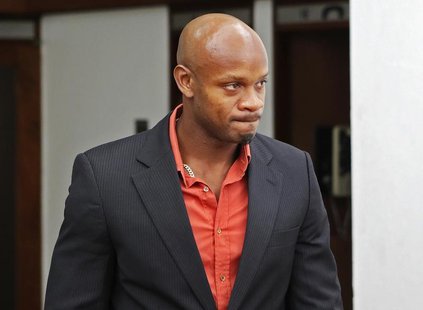 Jamaica's Olympic runner Asafa Powell, who tested positive for doping at the Jamaican Championships in 2013, takes a lunch break on the firs Jamaica's Olympic runner Asafa Powell, who tested positive for doping at the Jamaican Championships in 2013, takes a lunch break on the firs