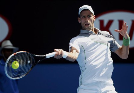 Novak Djokovic of Serbia hits a return to Leonardo Mayer of Argentina during their men's singles match at the Australian Open 2014 tennis to Novak Djokovic of Serbia hits a return to Leonardo Mayer of Argentina during their men's singles match at the Australian Open 2014 tennis to