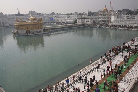 Devotees walk inside the complex of the holy Sikh shrine, the Golden Temple, in the northern Indian city of Amritsar January 14, 2014. REUTE Devotees walk inside the complex of the holy Sikh shrine, the Golden Temple, in the northern Indian city of Amritsar January 14, 2014. REUTE