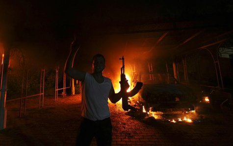 A protester reacts as the U.S. Consulate in Benghazi is seen in flames during a protest by an armed group said to have been protesting a fil A protester reacts as the U.S. Consulate in Benghazi is seen in flames during a protest by an armed group said to have been protesting a fil