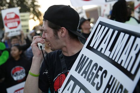 A man chants outside Wal-Mart during a protest for better wages and working conditions during Black Friday in San Leandro, California Novemb A man chants outside Wal-Mart during a protest for better wages and working conditions during Black Friday in San Leandro, California Novemb