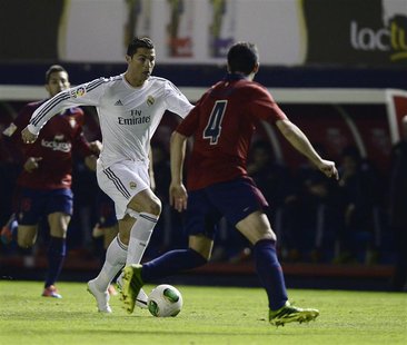 Osasuna's Miguel Flano (R) fights for the ball with Real Madrid's Cristiano Ronaldo during their Spanish King's Cup soccer match at Reyno de Osasuna's Miguel Flano (R) fights for the ball with Real Madrid's Cristiano Ronaldo during their Spanish King's Cup soccer match at Reyno de