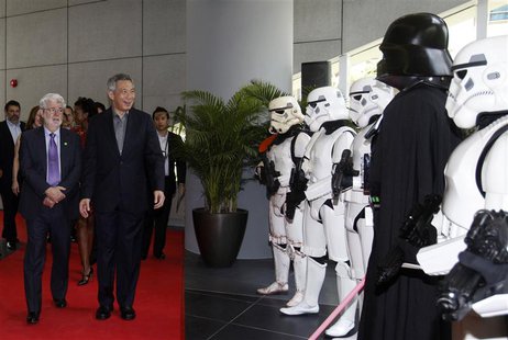 Filmmaker George Lucas welcomes Singapore's Prime Minister Lee Hsien Loong as they walk past people dressed up as Stormtroopers and Darth Va Filmmaker George Lucas welcomes Singapore's Prime Minister Lee Hsien Loong as they walk past people dressed up as Stormtroopers and Darth Va