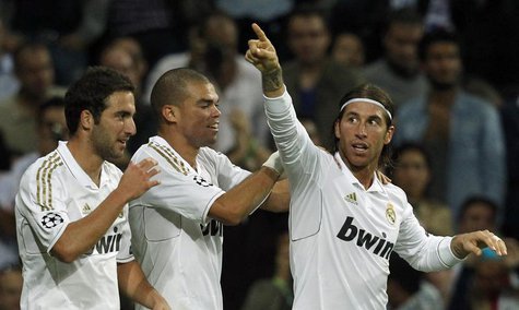 Real Madrid's Gonzalo Higuain (L) and Pepe congratulate teammate Sergio Ramos (R) after scoring a goal against Olympique Lyon during their C Real Madrid's Gonzalo Higuain (L) and Pepe congratulate teammate Sergio Ramos (R) after scoring a goal against Olympique Lyon during their C