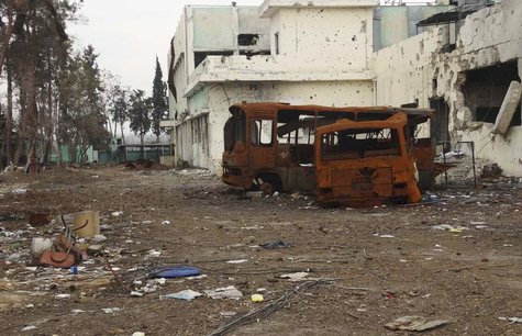 Damaged buses lie near the Tameko pharmaceutical factory, after the Free Syrian army claimed to have taken control of the factory, in easter Damaged buses lie near the Tameko pharmaceutical factory, after the Free Syrian army claimed to have taken control of the factory, in easter