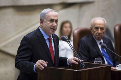 Israel's Prime Minister Benjamin Netanyahu (L) delivers a speech during a session marking the 65th anniversary of the Knesset, the Israeli p Israel's Prime Minister Benjamin Netanyahu (L) delivers a speech during a session marking the 65th anniversary of the Knesset, the Israeli p