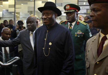Nigeria's President Goodluck Jonathan (C) arrives for the service for former South African President Nelson Mandela at the First National Ba Nigeria's President Goodluck Jonathan (C) arrives for the service for former South African President Nelson Mandela at the First National Ba
