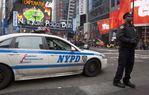 A police officer stands guard in Times Square, New York December 29, 2013. The area is under increased security as the New Year's Eve celebr A police officer stands guard in Times Square, New York December 29, 2013. The area is under increased security as the New Year's Eve celebr