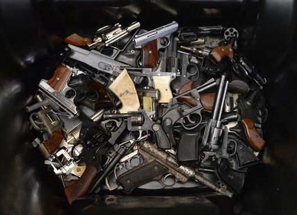 A pile of handguns are placed in a trash bin after they were surrendered during a gun buyback program organized by Mayor Eric Garcetti's Gan A pile of handguns are placed in a trash bin after they were surrendered during a gun buyback program organized by Mayor Eric Garcetti's Gan