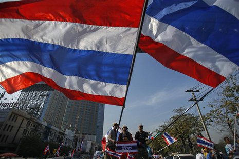 Anti-government protesters wave Thai national flags before marching towards the Public Health Ministry in Bangkok January 16, 2014. REUTERS/ Anti-government protesters wave Thai national flags before marching towards the Public Health Ministry in Bangkok January 16, 2014. REUTERS/
