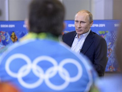 Russia's President Vladimir Putin (back) meets with volunteers who are taking part in the preparations for the Sochi 2014 Winter Olympic Gam Russia's President Vladimir Putin (back) meets with volunteers who are taking part in the preparations for the Sochi 2014 Winter Olympic Gam