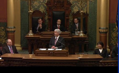 Governor Snyder with the Lt. Governor, the Speaker of the House and the Majority Leader of the Senate sitting behind him. Governor Snyder with the Lt. Governor, the Speaker of the House and the Majority Leader of the Senate sitting behind him.