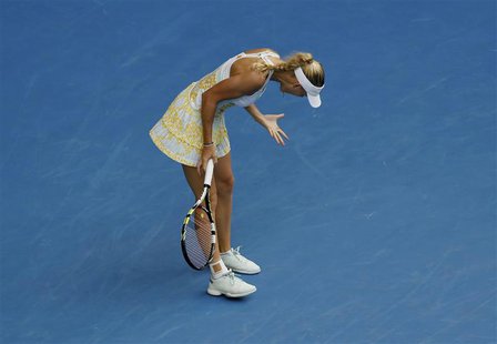 Caroline Wozniacki of Denmark reacts during her women's singles match against Garbine Muguruza of Spain at the Australian Open 2014 tennis t Caroline Wozniacki of Denmark reacts during her women's singles match against Garbine Muguruza of Spain at the Australian Open 2014 tennis t