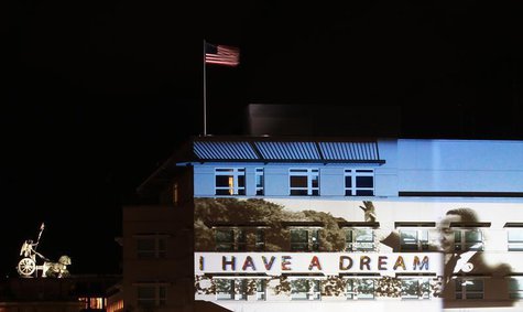 A light installation showing Martin Luther King Jr. is projected on the facade of the U.S. Embassy, next to the Quadriga (L) atop of the Bra A light installation showing Martin Luther King Jr. is projected on the facade of the U.S. Embassy, next to the Quadriga (L) atop of the Bra