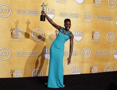 Actress Lupita Nyong'o poses with her award for outstanding performance by a female in a supporting role for her role in "12 Years a Slave" Actress Lupita Nyong'o poses with her award for outstanding performance by a female in a supporting role for her role in "12 Years a Slave"