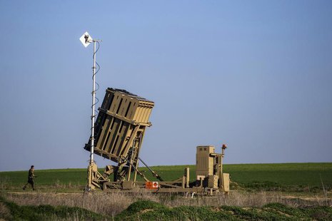 An Israeli soldier walks near the launcher of an Iron Dome missile interceptor battery deployed in the southern Israeli coastal city of Ashk An Israeli soldier walks near the launcher of an Iron Dome missile interceptor battery deployed in the southern Israeli coastal city of Ashk
