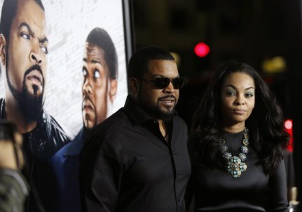 Cast member Ice Cube and his wife Kimberly Woodruff pose at the premiere of "Ride Along" at the TCL Chinese theatre in Hollywood, California Cast member Ice Cube and his wife Kimberly Woodruff pose at the premiere of "Ride Along" at the TCL Chinese theatre in Hollywood, California