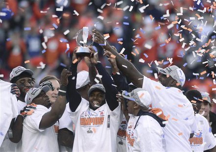 Denver Broncos players hold up the Lamar Hunt Trophy after they defeated the New England Patriots in the NFL's AFC Championship football gam Denver Broncos players hold up the Lamar Hunt Trophy after they defeated the New England Patriots in the NFL's AFC Championship football gam