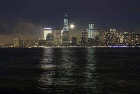 A full moon rises behind the skyline of Lower Manhattan and One World Trade Center in New York, January 15, 2014. REUTERS/Gary Hershorn A full moon rises behind the skyline of Lower Manhattan and One World Trade Center in New York, January 15, 2014. REUTERS/Gary Hershorn